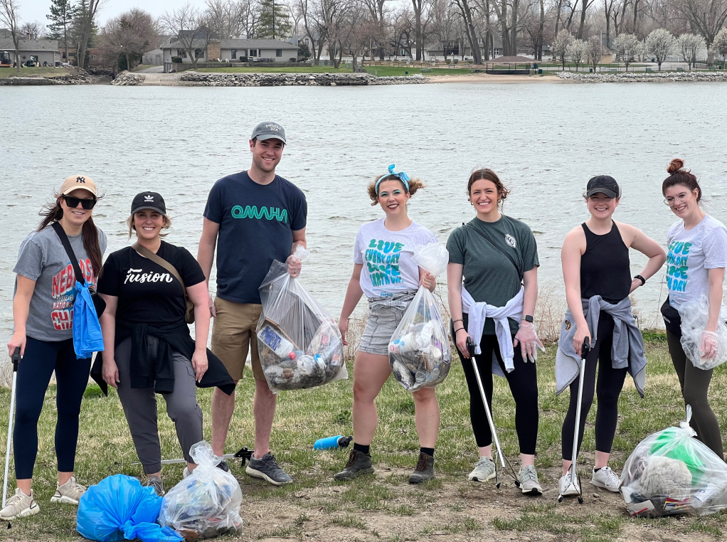 Company team volunteering for trash pickup in a neighborhood