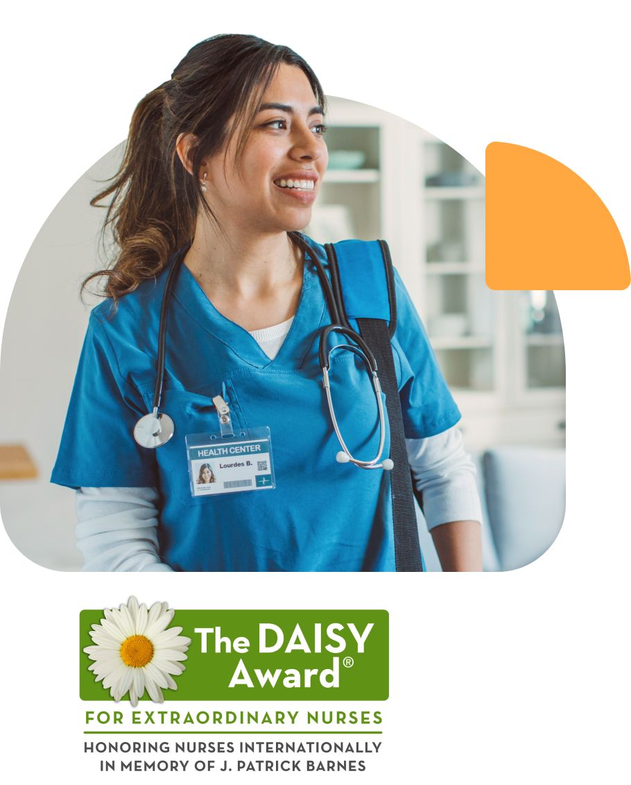 A nurse standing and smiling as the winner of the international DAISY Award
