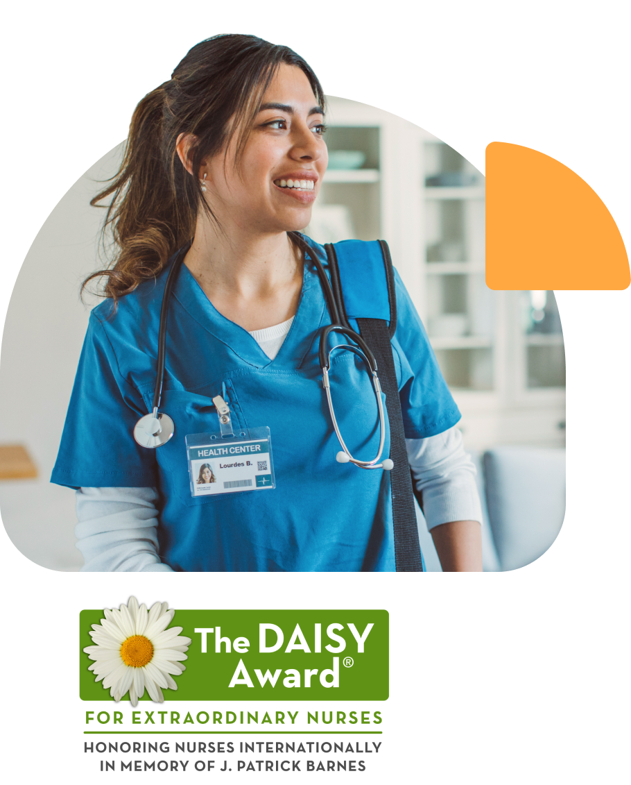 Impact-group3 A nurse standing and smiling as the winner of the international DAISY Award