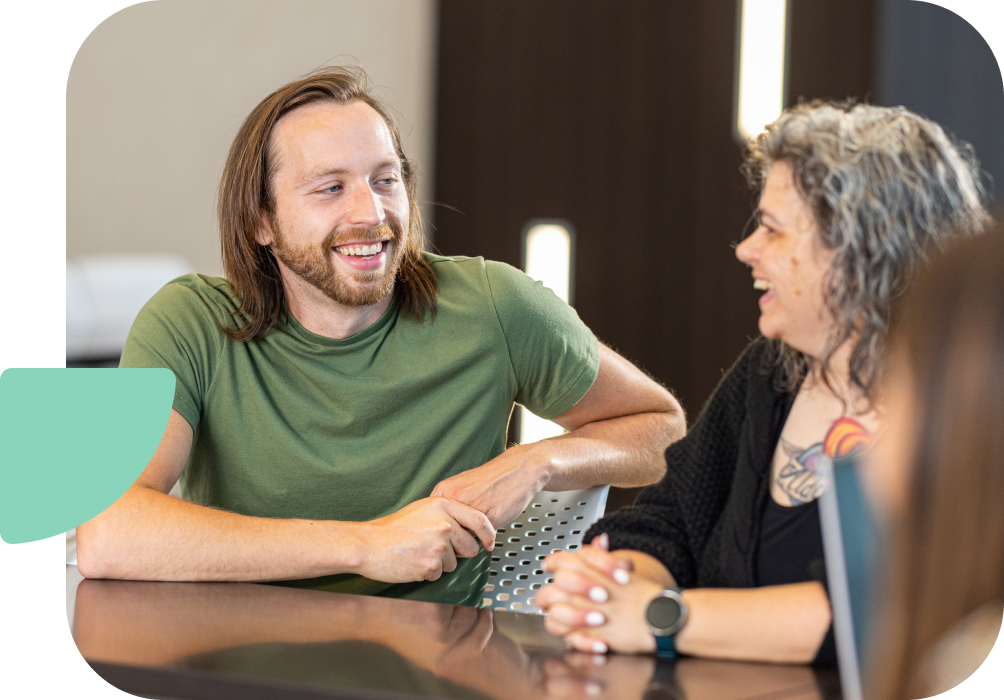 two people laughing at a table